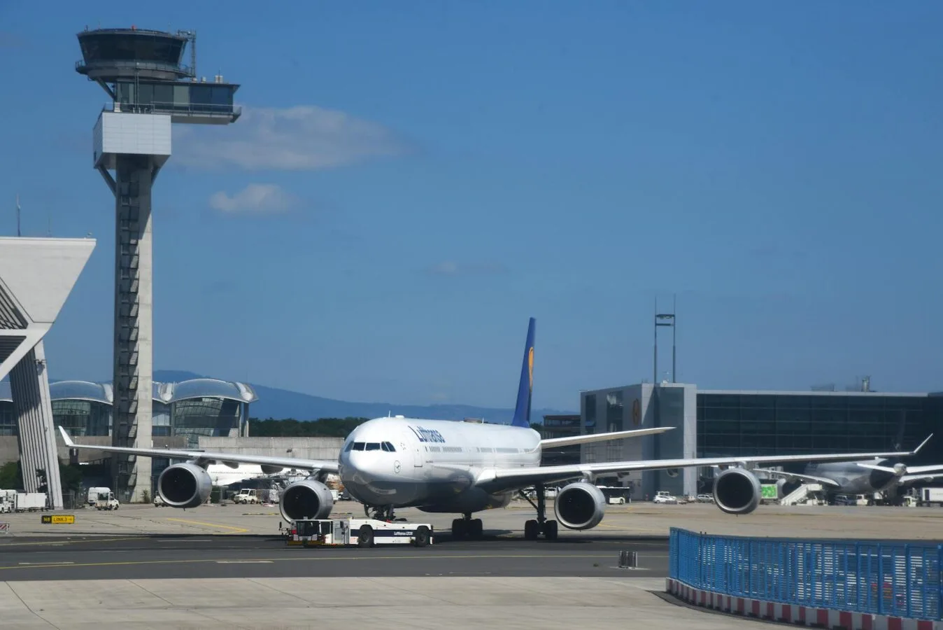 Großraumflugzeug der Lufthansa am Rollfeld vor Tower und Terminal am Flughafen Frankfurt Fraport