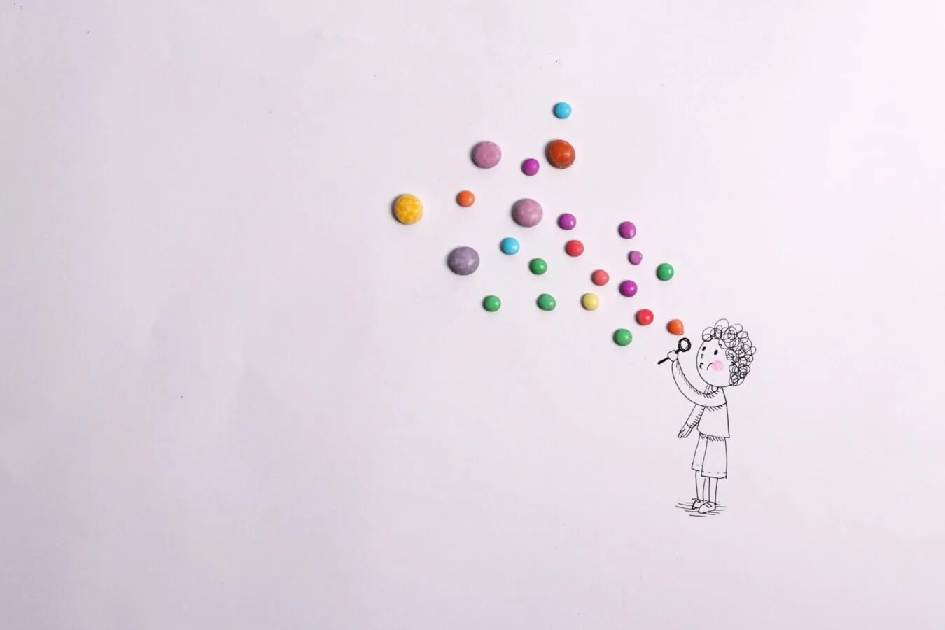 Strichzeichnung Kind bläst bunte Bonbons als Luftballons, Gutschein ExtraMeilen Flughafen Frankfurt Thema