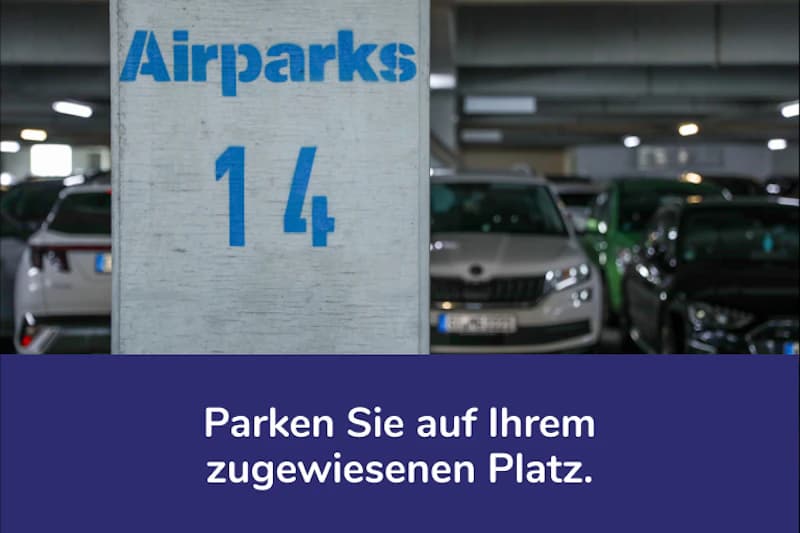 Betonpfeiler mit Airparks-Logo und großer Zahl 14, im Hintergrund geparkte Autos im Parkhaus.