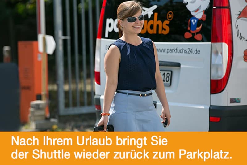 Frau mit Sonnenbrille und Tasche vor Parkfuchs24-Transporter stehend.